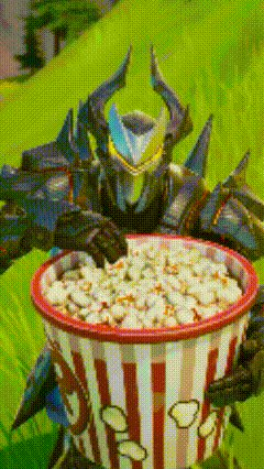 a knight is holding a bowl of popcorn in his hands .