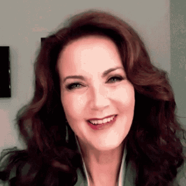 a close up of a woman 's face with a smile on her face .