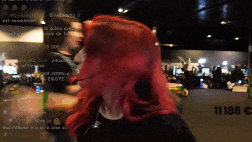 a woman with red hair stands in front of a blurred background that says 111815