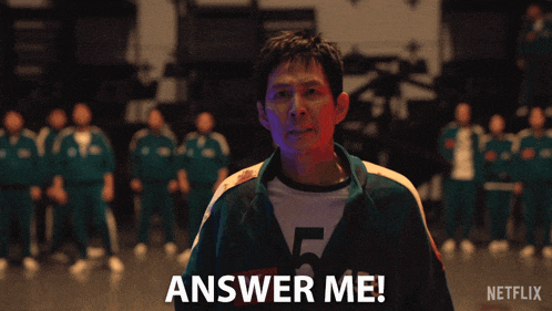 a man screaming in front of a group of people with the words answer me