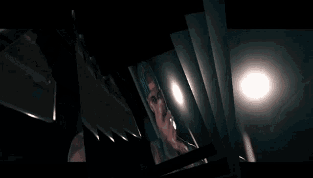 a man with a tattoo on his arm is looking at his reflection