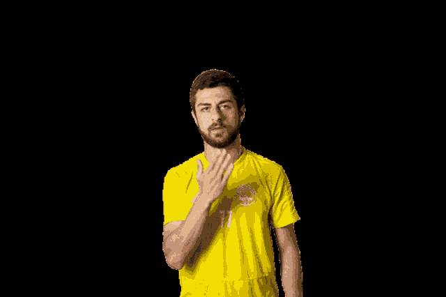 a man wearing a yellow shirt with the number 17 on the front