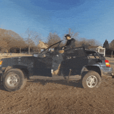a man sits in the back of a jeep with the door open