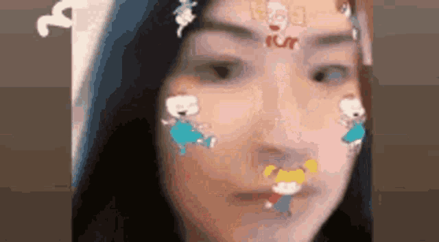 a close up of a woman 's face with stickers on her face .
