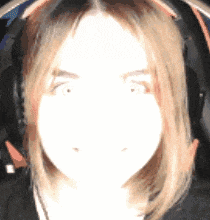 a close up of a woman wearing headphones with a white background .