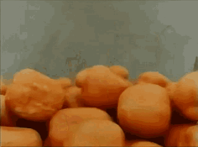 a bunch of oranges are being peeled on a conveyor belt