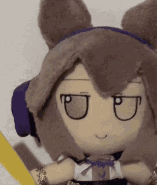 a stuffed animal with a purple headband and a sword