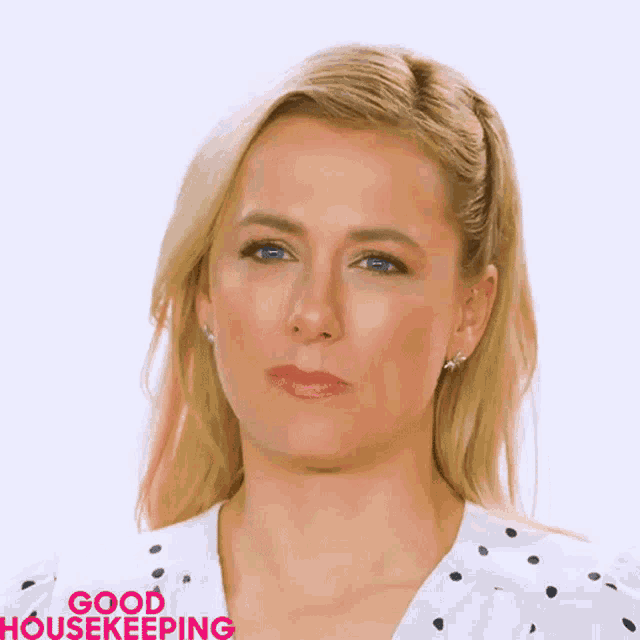 a woman in a white polka dot shirt with the words good housekeeping on the bottom right
