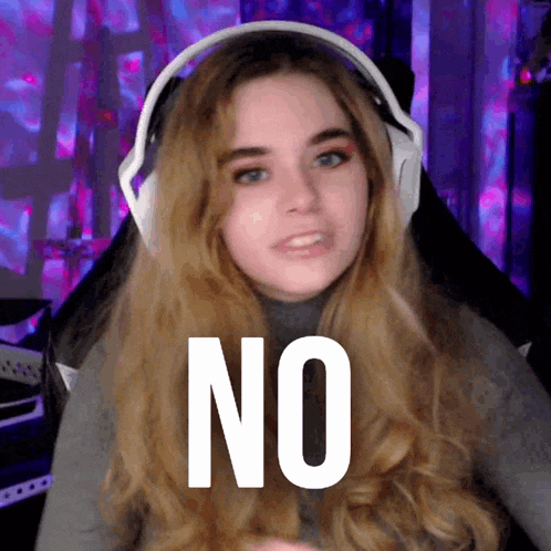 a woman wearing headphones with the word no written on her face