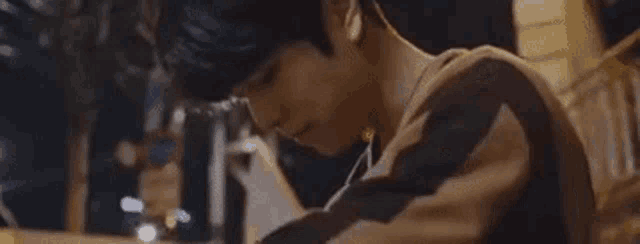 a man is sitting on a set of stairs using a cell phone .
