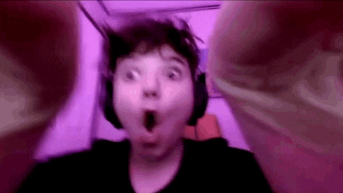 a close up of a person wearing headphones with their mouth open .