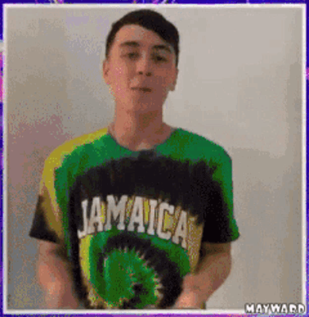 a man wearing a jamaica shirt is standing in front of a wall