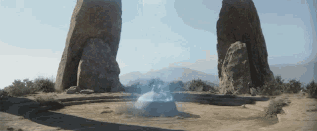 a circle of rocks with a blue light coming out of one of them