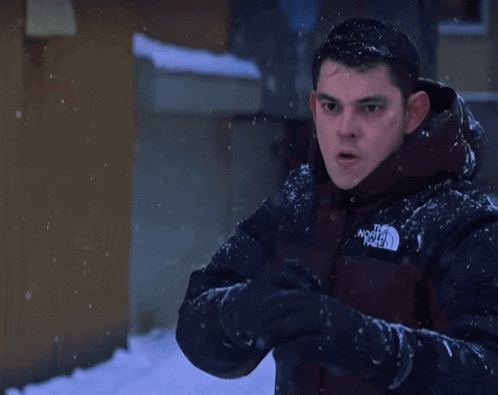 a man wearing a jacket that says the north face