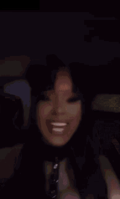 a blurry image of a person 's face with a pink object in the background
