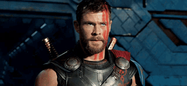 a man with blood on his face and a sword