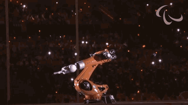 a robotic arm is shown in front of a crowd
