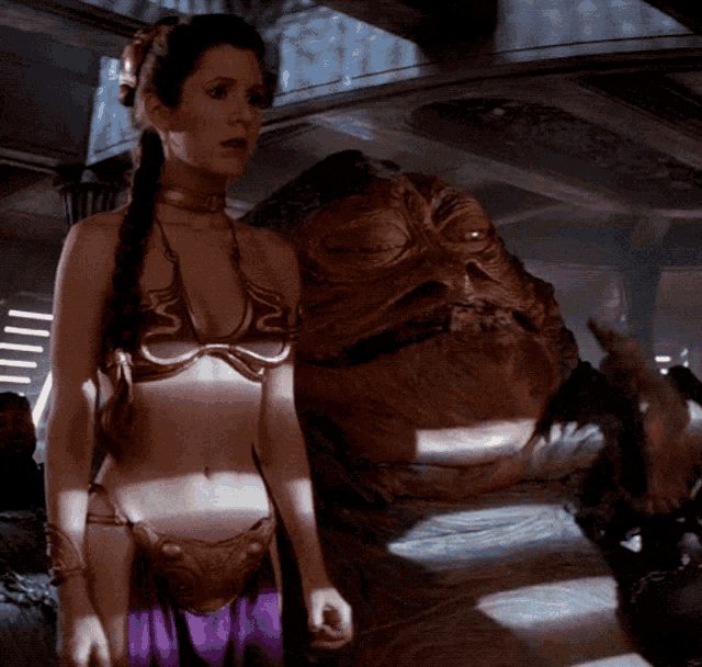 a woman in a bikini stands next to a giant frog