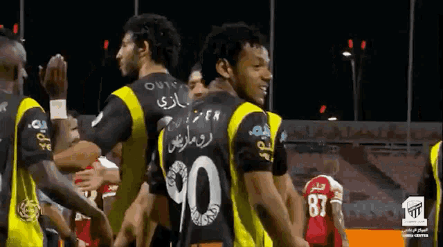 a group of soccer players with one wearing a number 90 jersey