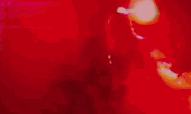 a blurred image of a man playing a drum set
