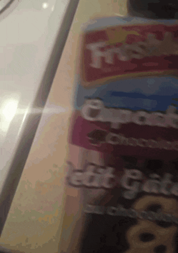 a close up of a box of frosted cookies