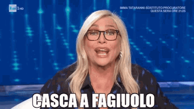a woman wearing glasses says casca a fagiuolo on the screen