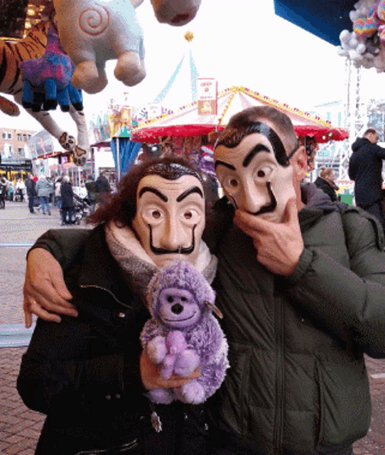 a man and woman wearing masks are posing for a picture