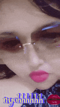 a close up of a woman 's face with sunglasses and the words ngohhhh written on the bottom
