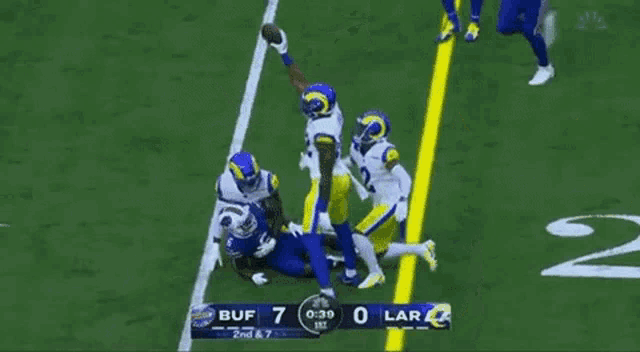 a football game is being played between the rams and the ravens