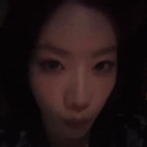 a close up of a woman 's face in the dark .