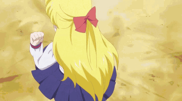 a girl with a red bow on her head is being punched