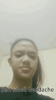 a woman is taking a selfie with the words bad smell headache on her face .