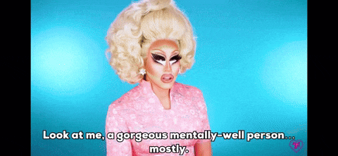 a drag queen in a pink dress says " look at me a gorgeous mentally well person mostly "