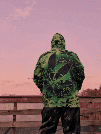 a person wearing a green jacket with a leaf on it