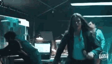 a woman with long hair is sitting in a dark room .