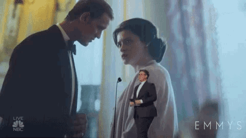 a man and woman are standing next to each other in a room .
