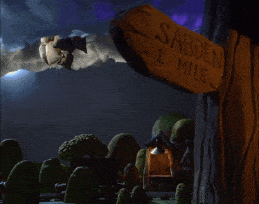 a sign that says ' sabden 1 mile ' on it in front of a hot air balloon