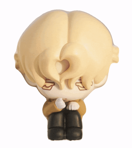 a figurine of a boy with blonde hair is sitting on a white background