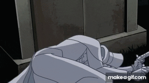 a person is laying on the ground holding a gun .