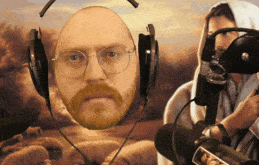 a man wearing glasses and headphones is standing in front of a microphone
