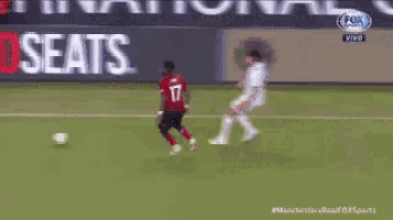 a soccer game is being played on a field sponsored by sears