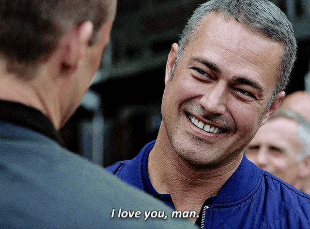 a man in a blue jacket is smiling and says " i love you man "