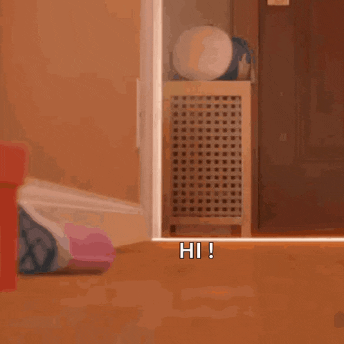 a stuffed bunny rabbit is peeking out of a door and says hi !