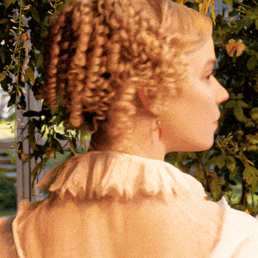 a woman with blonde curly hair is wearing a white collared shirt