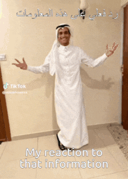 a man in a white robe with arabic writing on it