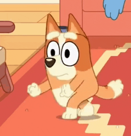 a cartoon dog is standing on a red rug on the floor .