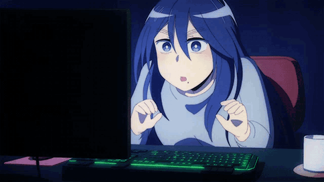 a girl with blue hair looks at a computer screen