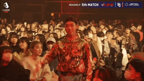 a man stands in front of a crowd with a sign that says ace performer 5 sho dip battles