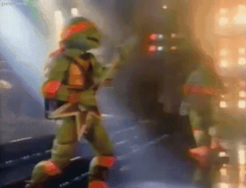 two teenage mutant ninja turtles are dancing on a stage