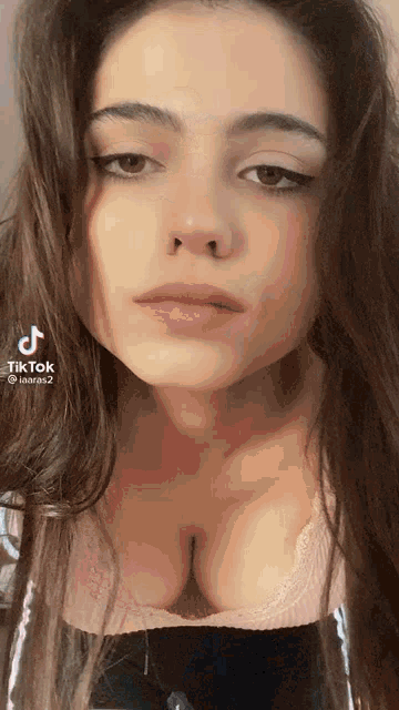 a close up of a woman 's face with a very large breast